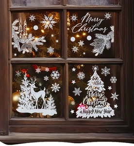 White Christmas window decals with reindeer and snowflakes on a wooden frame