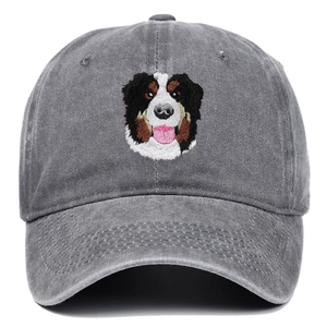 Close-up of detailed Bernese Mountain Dog embroidery on grey washed denim baseball cap