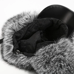 Detailed macro view of winter trapper hat with quilted lining and faux fur trim texture