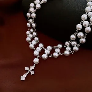 Elegant multi-layer pearl necklace with a zircon cross pendant in a vintage luxury style