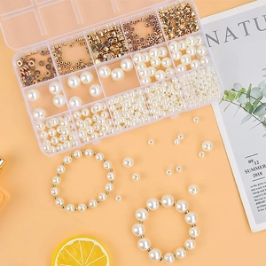 Detailed macro shot of 770pcs DIY pearl bead set with gold spacers in storage box