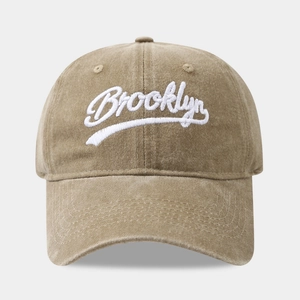 Close-up of khaki washed cotton baseball cap with white Brooklyn embroidery detail