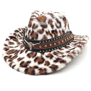 Detail of leopard print cowboy hat featuring a leather band with bull head and rhinestones