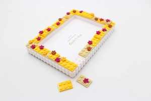 Detail of DIY building block photo frame with colorful bricks and 4x6 star decorations