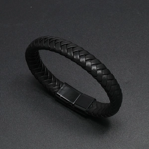 Close-up of black braided leather men's bracelet with a sleek magnetic metal clasp
