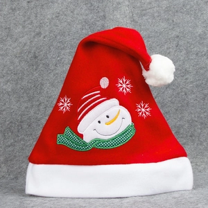 Red Christmas hat with snowman embroidery, white plush brim and pompom on gray background