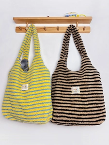 Close-up of Maillard style striped plush tote bags made of soft lamb wool material