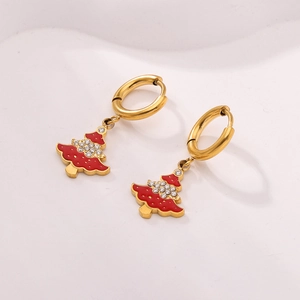 Detail of gold Christmas tree earrings with red enamel and sparkling rhinestones