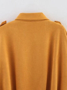 Close-up view of mustard yellow faux suede bomber jacket showing collar and seam details