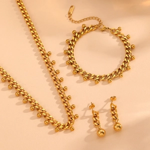 Golden stainless steel jewelry set featuring beaded Cuban chain necklace and bracelet