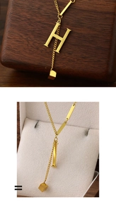 Macro detail of gold plated titanium steel necklace featuring letter H and square pendant