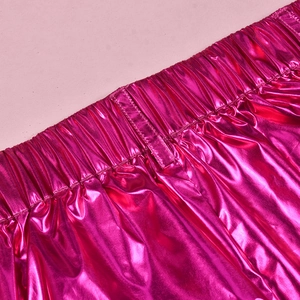 Detail of high-waist elastic band on pink metallic shiny joggers with fine stitching
