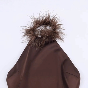 Brown satin halter neck dress featuring luxurious ostrich feather trim and smooth finish