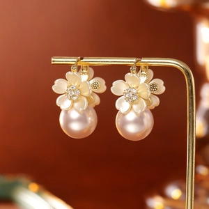 Elegant gold earrings with pink pearls and cream shell flower charms for women