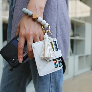 Wristlet keychain set with marble leather card holder and beaded silicone bracelet detail
