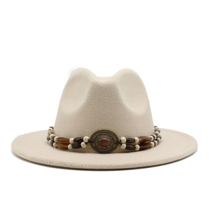 Detail of bohemian wool felt fedora featuring vintage beaded band and turquoise emblem