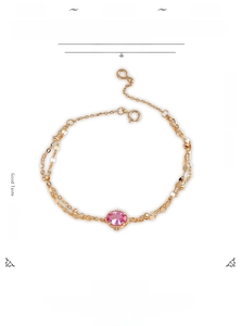 Detail view of 14K gold plated silver bracelet with pink corundum and double chain