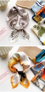 Detailed close-up of patterned silk scarves on decorative trays with artistic accents