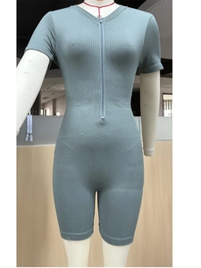Green seamless ribbed knit yoga bodysuit with front zipper and slim fit design