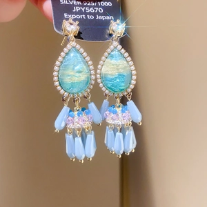 Detailed close-up of 925 silver bohemian drop earrings with blue teardrop stones