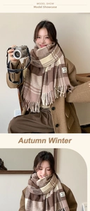 Detail of checkered autumn winter scarf featuring fringe edges and fashion label patch