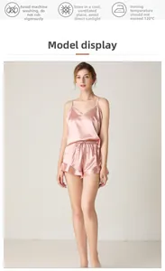 Detail showing the pink satin pajama camisole with a V-neckline and delicate straps
