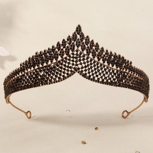 Detailed view of vintage black bridal crown with V-shaped metal design and gemstones