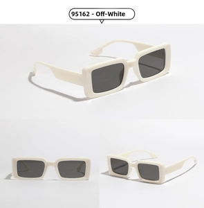 Detail view of cream-white rectangle sunglasses with thick frames and dark lenses