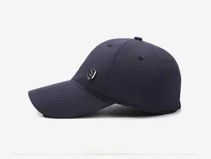 Side view of dark blue waterproof baseball cap with silver metal shield logo detail