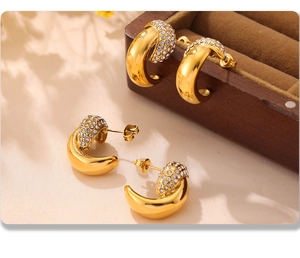 Macro shot of 18k gold plated crescent earrings with sparkling pave zircon settings