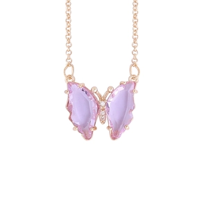 Golden butterfly necklace with pink gemstone wings and crystal pendant on white background