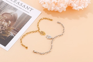 Detailed view of gold and silver Hamsa Hand bracelets with elegant hollow-out design