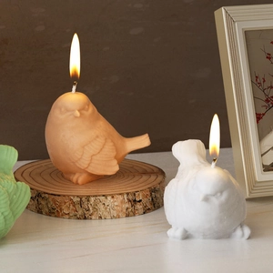 3D bird shaped scented candles with detailed feather texture in pink and white