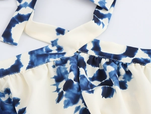 Detailed view of halter neckline with blue and white geometric tie-dye print
