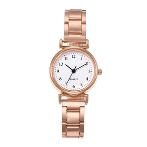 Minimalist rose gold quartz watch with white dial and metal strap on white background