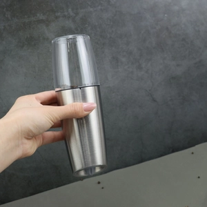 Close-up of electric pepper grinder with stainless steel body and clear acrylic window