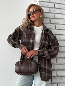 Close-up of brown plaid shirt with white inner tee and vintage leather handbag