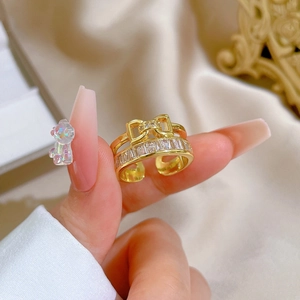 Adjustable gold plated bow ring featuring double layers of sparkling cubic zirconia