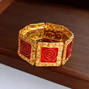 Vintage gold square elastic bracelet with red enamel inlay and spiral motif