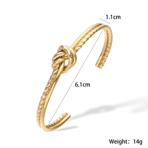 Detailed view of gold knot open bangle with dimensions 1.1cm width and 14g weight