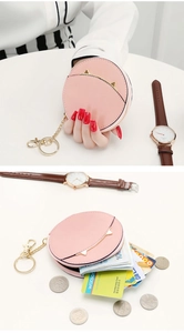Macro view of pink cat-ear coin purse with ring zipper and golden keychain detail