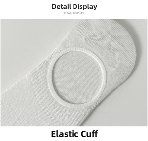 Macro shot of white cotton no-show socks featuring elastic ribbed cuff and high-density knit