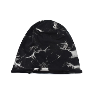 Close-up of black and white tie-dye knit beanie with marbled pattern and rolled edge