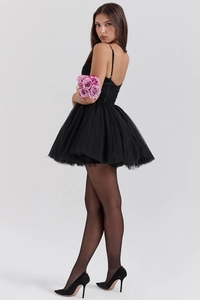 Detail of black mesh patchwork mini dress with backless design and puffy tutu skirt