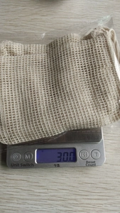 Detail showing natural jute soap pouch on a digital scale weighing exactly 30 grams