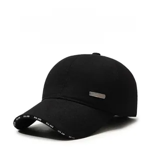 Detail of warm black baseball cap featuring ear protection and metal fashion badge