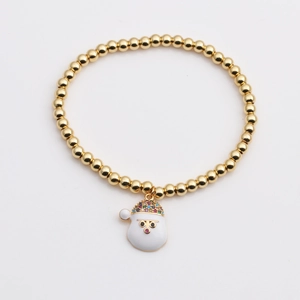 Détail du bracelet en perles dorées avec pendentif Père Noël en zircon pour Noël