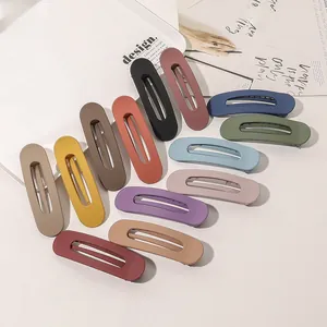 Detailed set of matte Morandi colored hair clips with hollow oval design on magazine