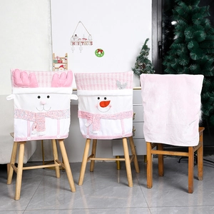 Pink reindeer and snowman plush Christmas chair covers for festive dining room decor