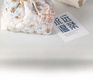 Floral quilted cotton drawstring pouch with padding detail and vintage floral patterns